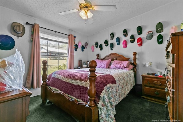 carpeted bedroom featuring ceiling fan and a textured ceiling