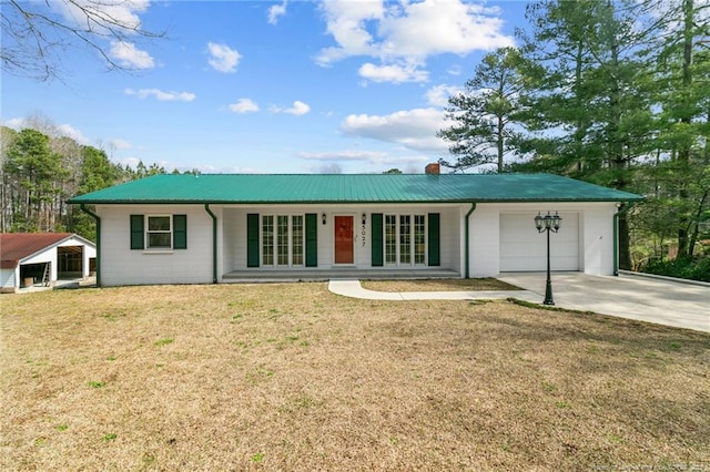 5027 Lake Willett Rd, Sanford, NC 27332 - single story home featuring driveway, a chimney, metal roof, an attached garage, and a front yard