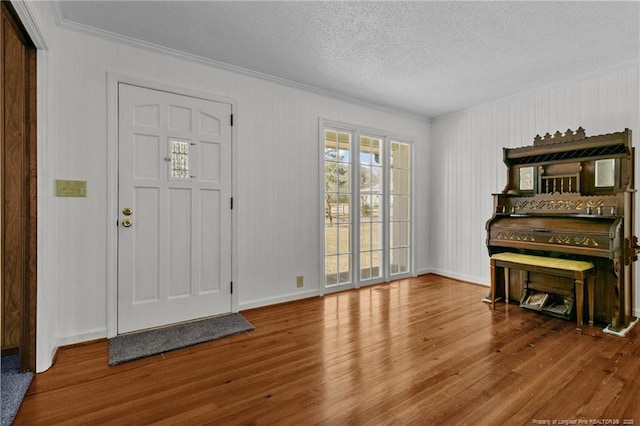 5027 Lake Willett Rd, Sanford, NC 27332 - entryway featuring baseboards, wood finished floors, a textured ceiling, and crown molding