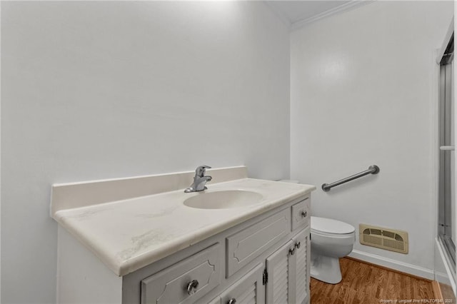 5027 Lake Willett Rd, Sanford, NC 27332 - full bath featuring wood finished floors, visible vents, toilet, vanity, and ornamental molding