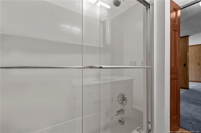 5027 Lake Willett Rd, Sanford, NC 27332 - bathroom featuring wood walls and enclosed tub / shower combo