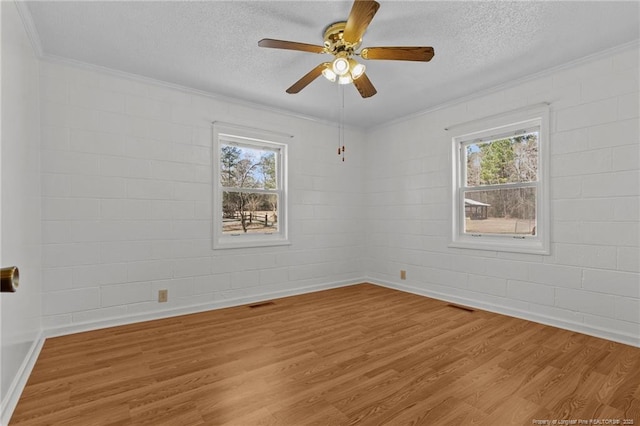 5027 Lake Willett Rd, Sanford, NC 27332 - unfurnished room featuring a wealth of natural light, ornamental molding, wood finished floors, and a textured ceiling
