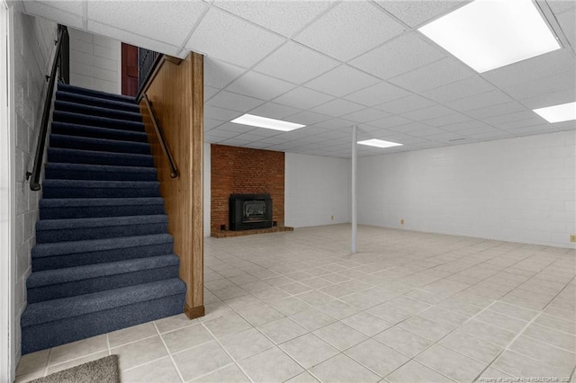 5027 Lake Willett Rd, Sanford, NC 27332 - finished basement featuring stairs, light tile patterned flooring, a fireplace, concrete block wall, and a paneled ceiling