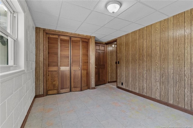 5027 Lake Willett Rd, Sanford, NC 27332 - unfurnished bedroom featuring wooden walls, a paneled ceiling, and a closet