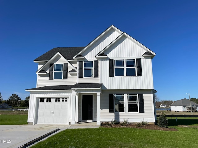 view of front of house with a front yard and a garage