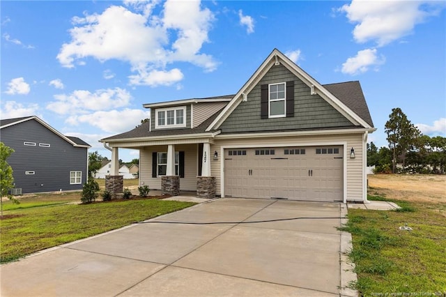 craftsman house featuring central air condition unit and a front yard