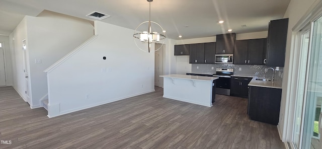 kitchen with visible vents, appliances with stainless steel finishes, dark wood-style flooring, light countertops, and a sink