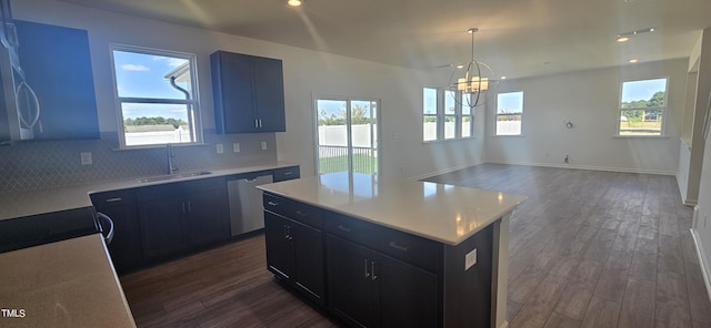 kitchen featuring decorative backsplash, dishwasher, dark wood-style floors, light countertops, and a sink