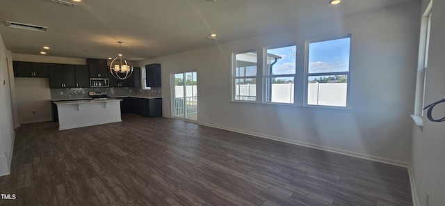 kitchen featuring dark wood-style flooring, stainless steel appliances, light countertops, visible vents, and dark cabinets