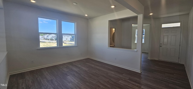 empty room featuring dark wood-style floors, recessed lighting, and baseboards