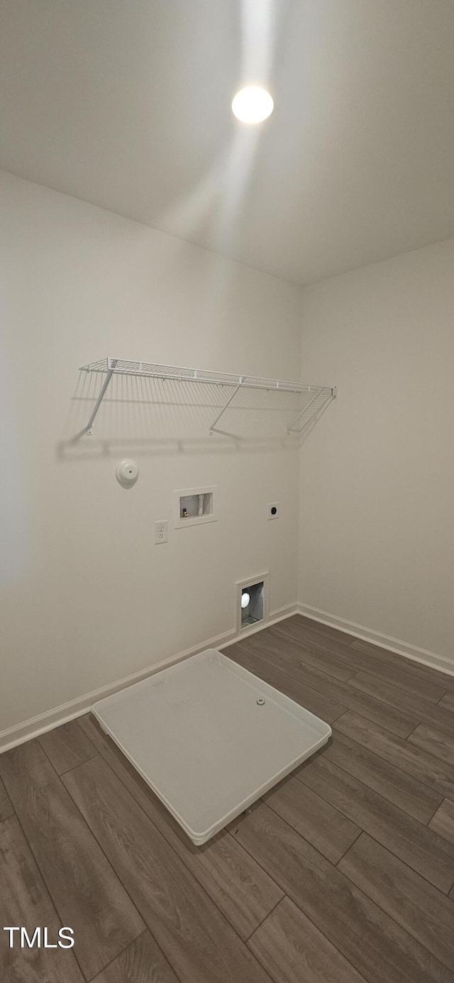 laundry area featuring laundry area, wood finished floors, electric dryer hookup, and baseboards