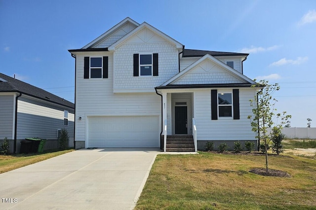 craftsman-style home with driveway, a front lawn, and an attached garage