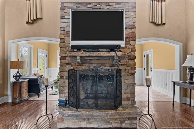 details featuring a stone fireplace and dark hardwood / wood-style floors