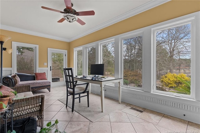 sunroom / solarium featuring ceiling fan