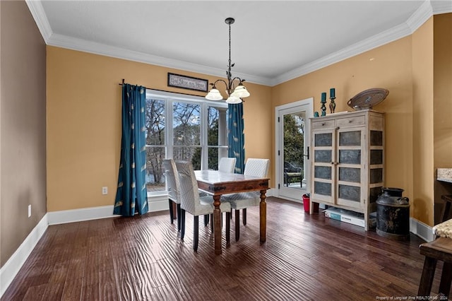 dining room with dark wood-type flooring, a notable chandelier, and ornamental molding