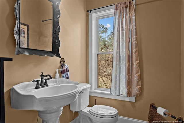 bathroom with sink, plenty of natural light, and toilet