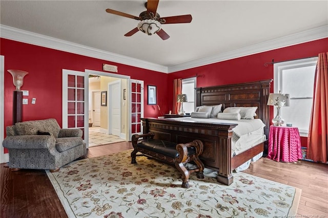 bedroom with light hardwood / wood-style floors, crown molding, and ceiling fan