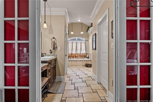 hall with ornamental molding, sink, and light tile floors