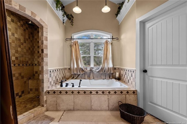 bathroom featuring tile flooring and separate shower and tub