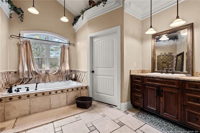 bathroom featuring tile flooring, a relaxing tiled bath, crown molding, vaulted ceiling, and vanity