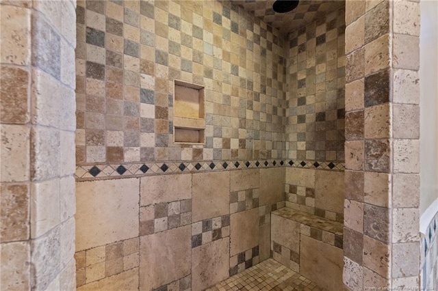 interior details featuring tiled shower