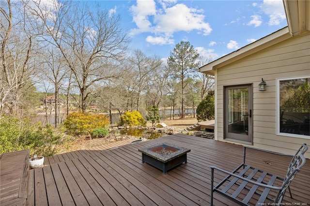 wooden terrace featuring a fire pit