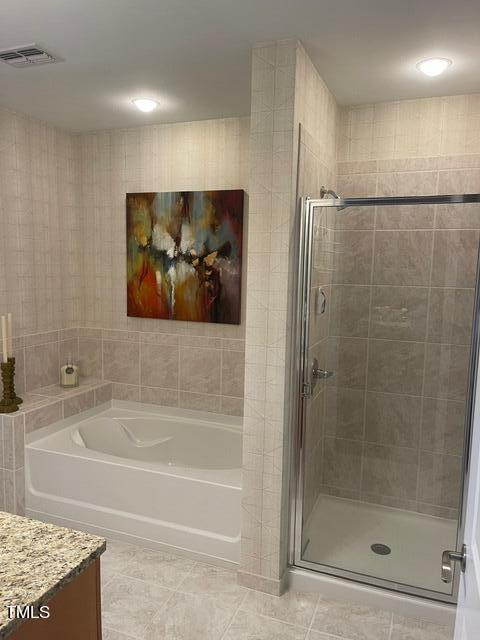 bathroom featuring vanity, tile floors, and independent shower and bath