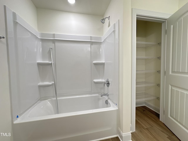 full bathroom featuring shower / bathtub combination, wood finished floors, and baseboards