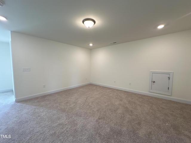 unfurnished room featuring recessed lighting, light colored carpet, visible vents, and baseboards