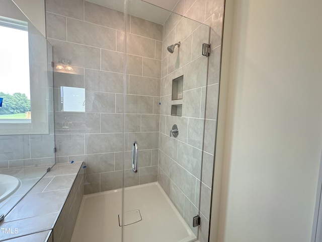 full bath with a stall shower and vanity