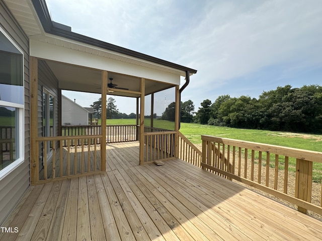 wooden deck featuring a lawn and a ceiling fan