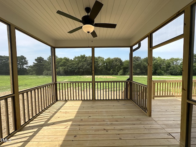 wooden deck featuring ceiling fan