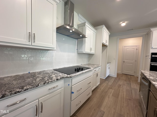 kitchen featuring black electric stovetop, backsplash, white cabinetry, dishwasher, and exhaust hood