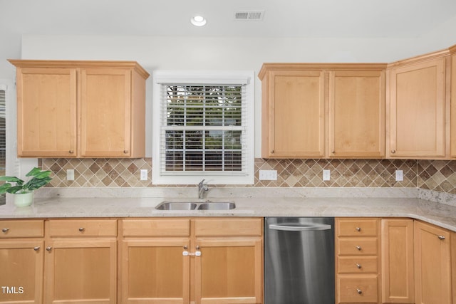 kitchen featuring stainless steel dishwasher, visible vents, light brown cabinetry, and a sink