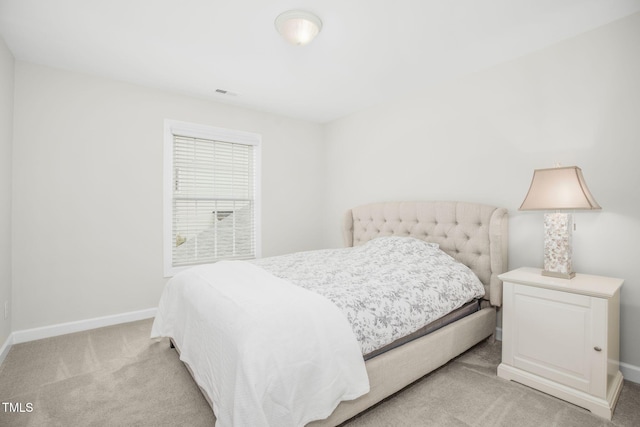 bedroom featuring light colored carpet, visible vents, and baseboards