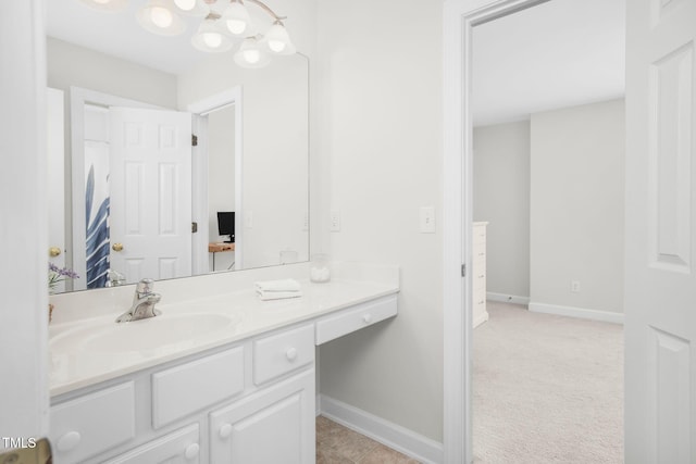 bathroom featuring baseboards and vanity