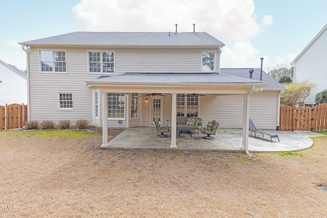 rear view of property with a ceiling fan, a patio, and fence