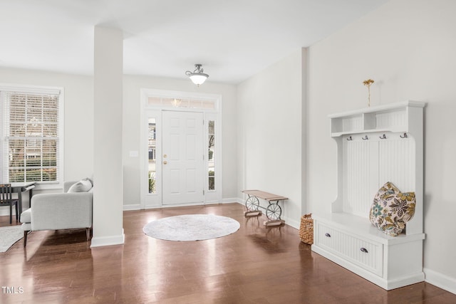 entryway featuring baseboards and wood finished floors