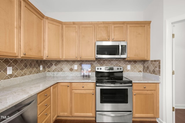 kitchen with tasteful backsplash, appliances with stainless steel finishes, baseboards, and light stone countertops