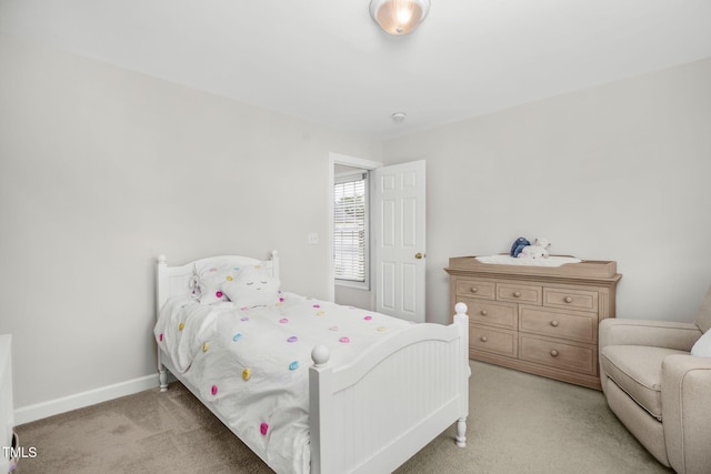 bedroom featuring baseboards and light carpet