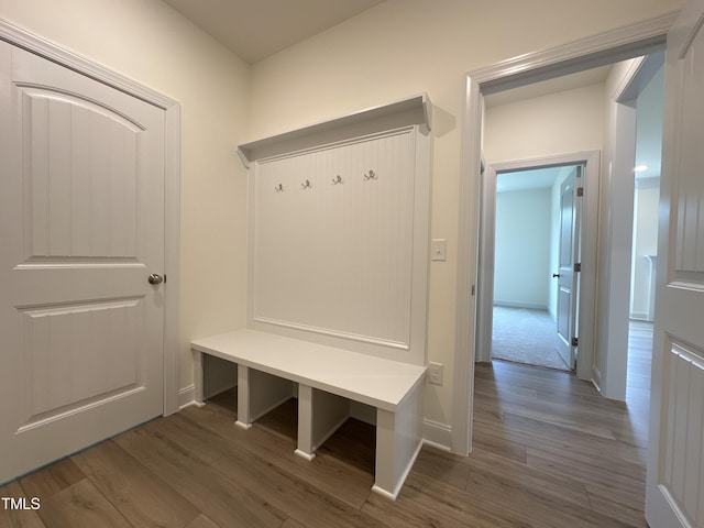 mudroom featuring wood finished floors and baseboards