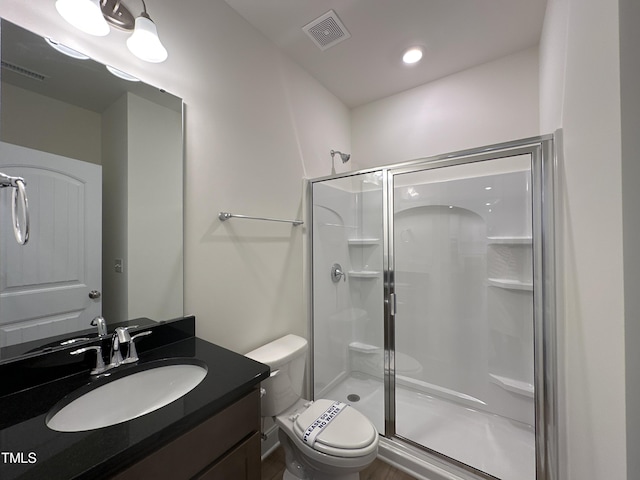 full bath featuring toilet, a shower stall, and visible vents