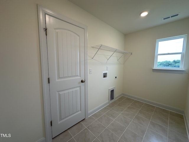 washroom featuring washer hookup, visible vents, light tile patterned flooring, electric dryer hookup, and laundry area