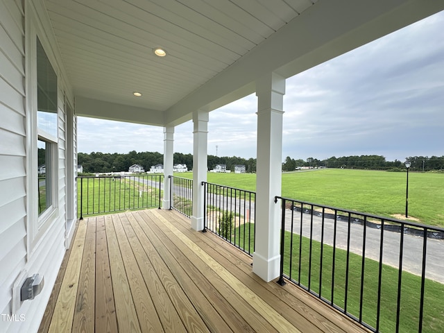 wooden deck featuring a lawn