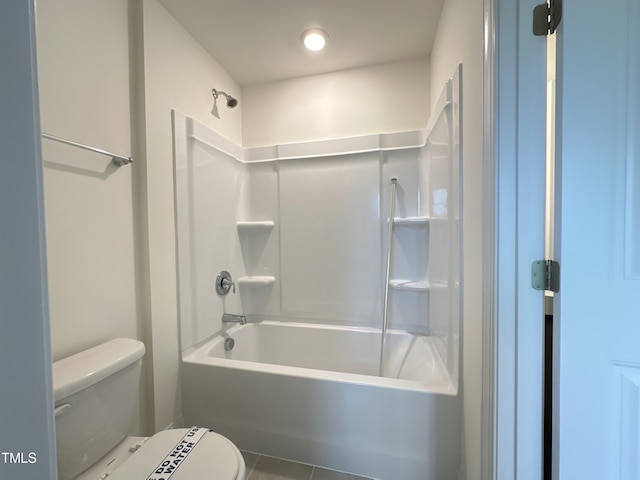 bathroom featuring toilet, shower / bath combination, and tile patterned floors