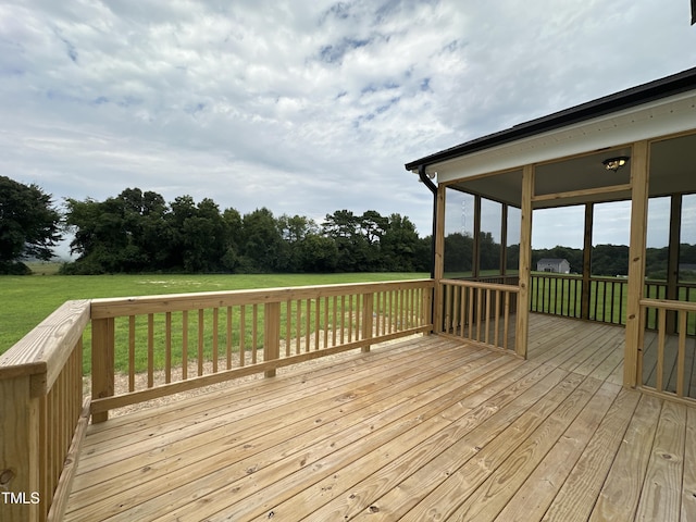 wooden deck with a lawn