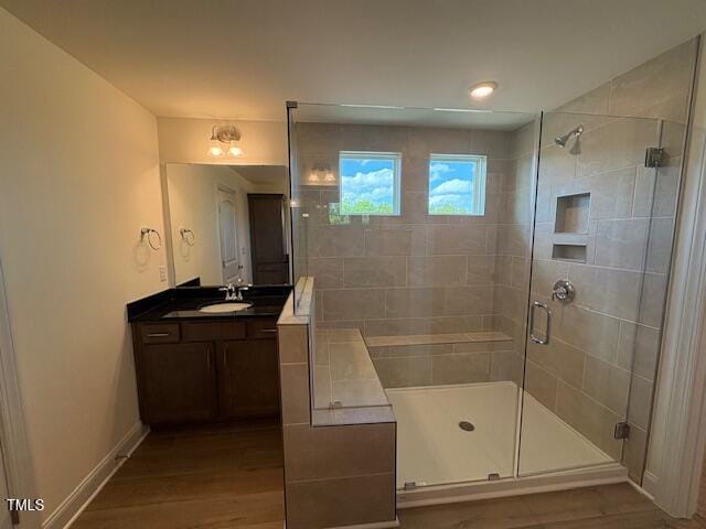 123 Sage Ln Unit 010, Four Oaks, NC 27524 - full bathroom with a shower stall, wood finished floors, vanity, and baseboards