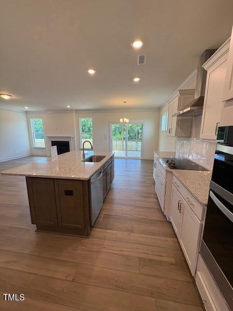 123 Sage Ln Unit 010, Four Oaks, NC 27524 - kitchen featuring a sink, stainless steel appliances, light wood-type flooring, a center island with sink, and recessed lighting