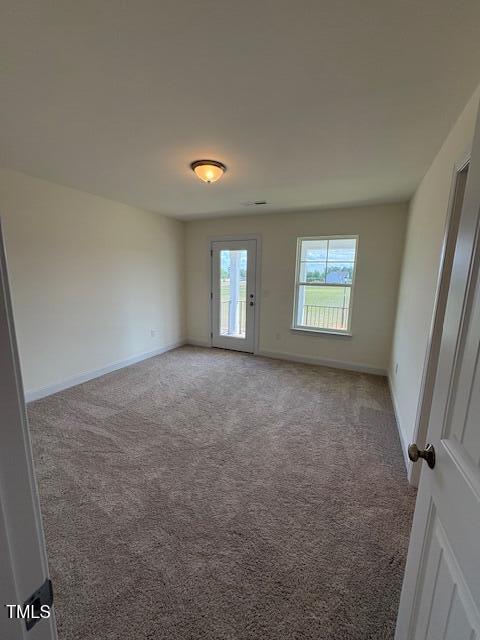 123 Sage Ln Unit 010, Four Oaks, NC 27524 - carpeted spare room featuring baseboards