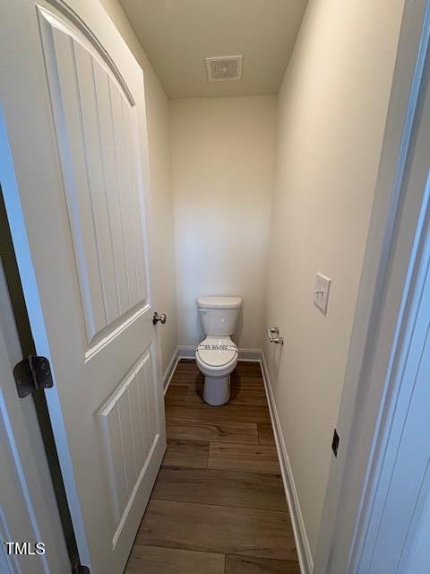 123 Sage Ln Unit 010, Four Oaks, NC 27524 - bathroom featuring wood finished floors, toilet, and baseboards